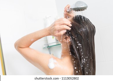 Woman In Shower Washing Hair With Shampoo.