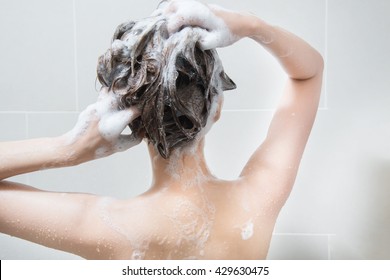 Woman In Shower Washing Hair With Shampoo.