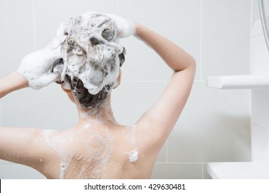 Woman In Shower Washing Hair With Shampoo.