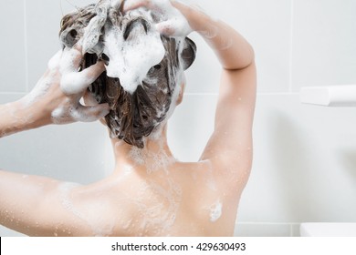 Woman In Shower Washing Hair With Shampoo.