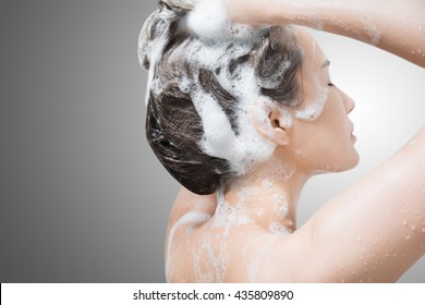 Woman In Shower Washing Hair With Shampoo.