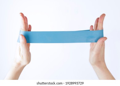 Woman showing a blue rubber band. Sport and healthy active lifestyle concept. 