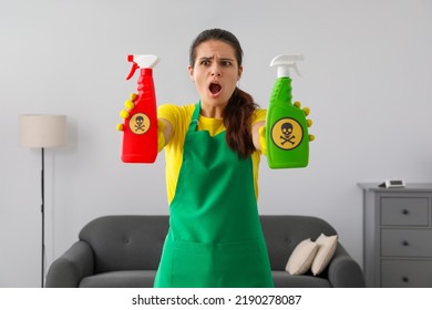 Woman Showing Bottles Of Toxic Household Chemical With Warning Signs