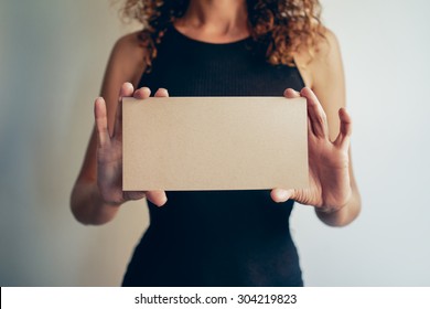 Woman Showing A Brown Blank Page Of Clipboard