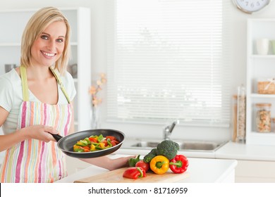 Woman Showing Cutted Peppers In Pan In The Kitchen