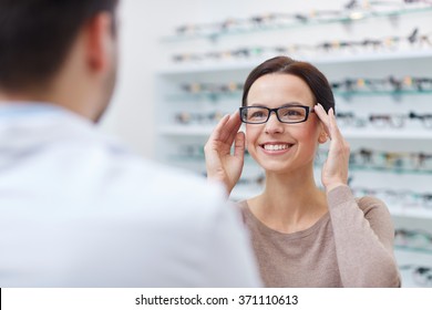 woman showing glasses to optician at optics store