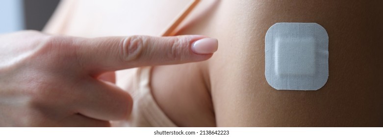 Woman Showing Her Finger Plaster Under Injection Site Of Coronavirus Vaccine Closeup