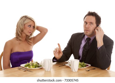 A Woman Showing Her Frustration With Her Man While They Are Having A Fancy Dinner He Is On The Phone Telling Her To Hang On A Minute.