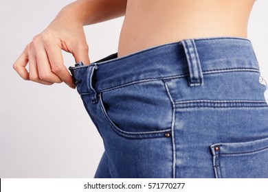 Woman Showing Loose Jeans, Loss Weight