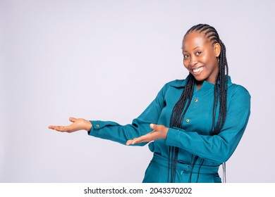 Woman showing pointing on background. Very fresh and energetic beautiful black africa young lady smiling happy presenting on white background. - Powered by Shutterstock