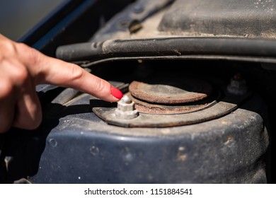 A Woman Is Showing A Rusty Strut Bearing.