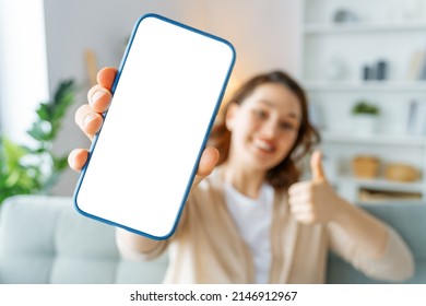 Woman showing smartphone. Blank screen mobile phone for graphic montage.