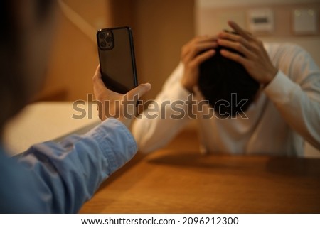 A woman showing a smartphone screen to a man