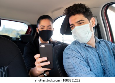 Woman Showing Something On Phone To Cab Driver.