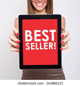 Woman Showing Tablet Computer That States Best Seller