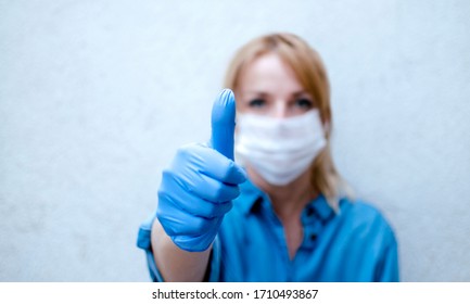 Woman Showing Thumb Up With Mask To Protect Her From Coronavirus.Caucasian Young Woman With Disposable Face Mask. Protection Versus Viruses And Infection Allergies Giving Thumbs Up