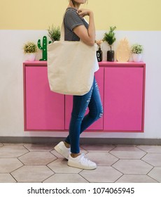 Woman Showing White Totebag. Tote Bag Mock Up For Designer. In Fun Background, Pink Yellow And Green Pallete