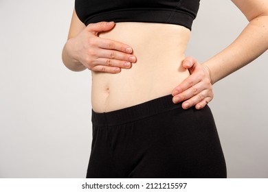 A Woman Shows The Location Of The Pancreas And Spleen, The Large Intestine. A Close-up Of The Abdomen.