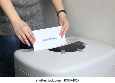 Woman Shredding Confidential Document