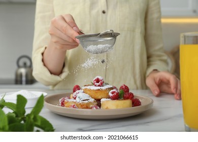 Woman sieving powdered sugar on cottage cheese pancakes at white table, closeup - Powered by Shutterstock