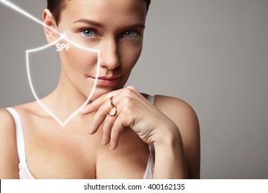 Woman With A Sign Of Spf Protection Shield And Ray Of Sun