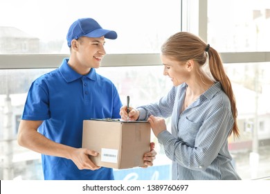 Woman Signing Documents To Confirm Receiving Of Order From Delivery Company