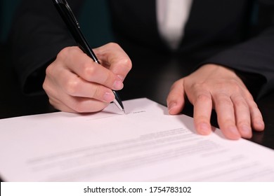 Woman Signs A Fake Contract, Close-up Of Hands With Pen On Paper With A Contract. No Faces, No Confidential Information, Fake Signature