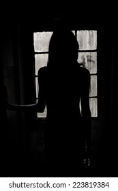 Woman Silhouette With Dirty Old Window In The Background