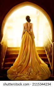 Woman Silhouette in Golden Luxury Gown. Elegant Lady in Yellow Long Silk Dress with naked Back Rear Side View. Fantasy Fashion Model Girl Looking at Light in Doorway