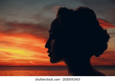 Woman silhouette with sun and clouds in her head - Shutterstock ID 2030592455