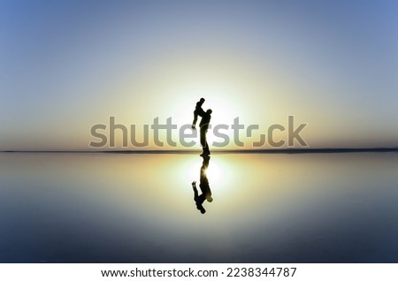 Woman silhouette view at sunset in amazing view of Salt Lake.