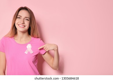Woman with silk ribbon and space for text on color background. Breast cancer awareness concept - Shutterstock ID 1303684618