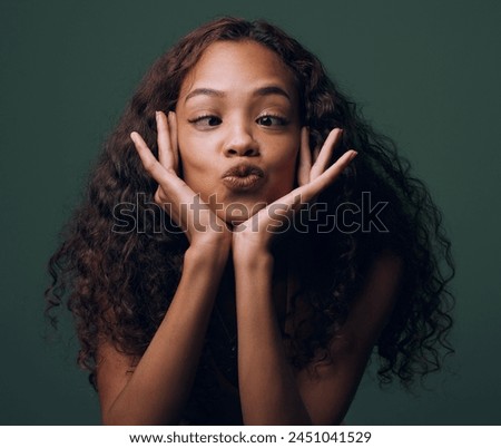 Woman, silly and face with goofy expression for funny joke, humor or comedy on a dark studio background. Young female person, brunette or quirky model with crazy pout, playful mind or fun attitude