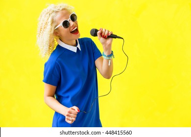 Woman Singing And Using Microphone