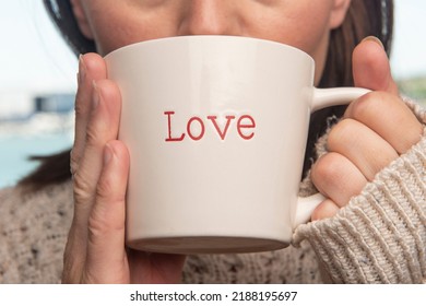 Woman Sipping From A Mug With 'love' Written On It, Close Up.