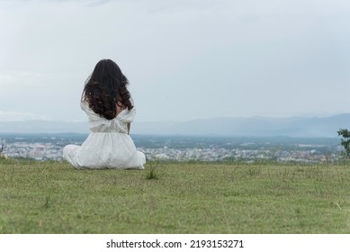 Woman Sit Down Turn Around On Grass At Park ,relax Time In Holiday.