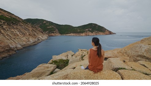 Woman Sit On The Rock And Enjoy The Landscape Scenery View