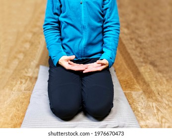 Woman Sit Up Straight With Their Legs Tucked Under Her