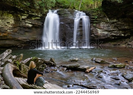 A woman sits by Seneca Creek below Seneca Falls in the Spruce Knob - Seneca Rocks National Recreation Area, part of the Monongahela National Forest in West Virginia.