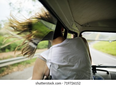 Woman Sitting In A Car Put Head Out Of Window Wind Blowing Her Hair