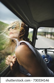 Woman Sitting In A Car Put Head Out Of Window Wind Blowing Her Hair