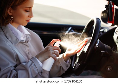 Woman Sitting In Car Using Hand Sanitizer In Bottle Against Dirt, Germs And Virus. Disinfection And Protection Of Private Place. Recommendation For Prevention Coronavirus Spread. 