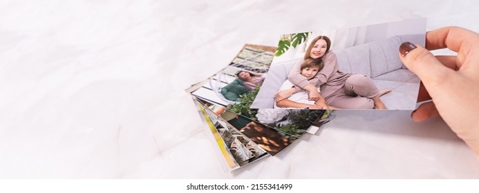 woman sitting at desk and looking at printed photos, remember nostalgia for a day of rest. photography cards, background. Mock up. banner - Shutterstock ID 2155341499