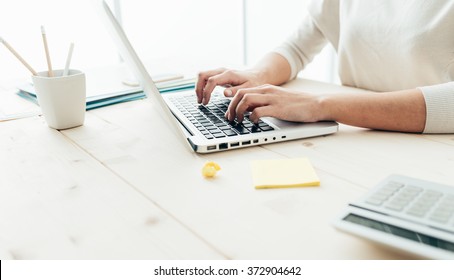 Woman sitting at desk and working at computer hands close up - Shutterstock ID 372904642