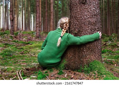 Woman sitting in forest and enjoys beauty of nature. - Shutterstock ID 2161747847