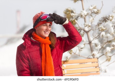 Woman Sitting In Front Of A Ski Hut Looking In The Alpine Landscape