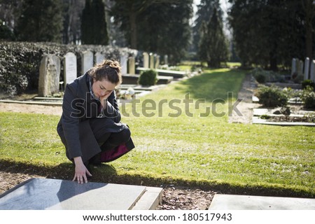 Woman sitting at grave