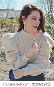 Woman Sitting And Holding Heart Sucker