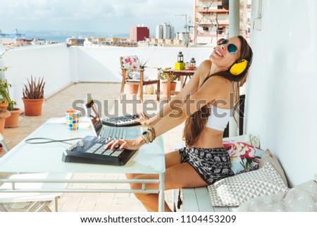 woman sitting with mixing table, in the terrace