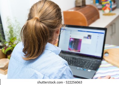 Woman Sitting Next To Laptop Screen. Caucasian Woman And Computer